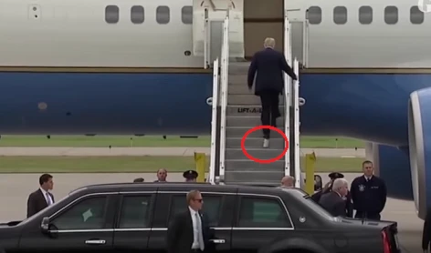 Trump con el papel higiénico pegado al pie izquierdo.