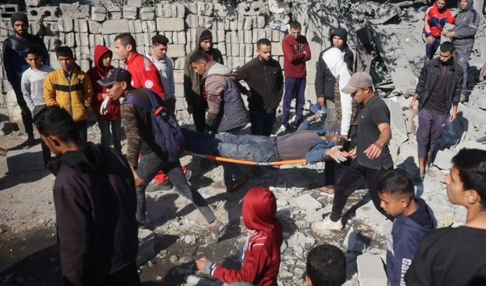 Palestinos evacúan a un herido tras un ataque israelí contra el campo de refugiados de Bureij, en el Centro de la Franja de Gaza. 2 de diciembre de 2024 (Foto: AFP)