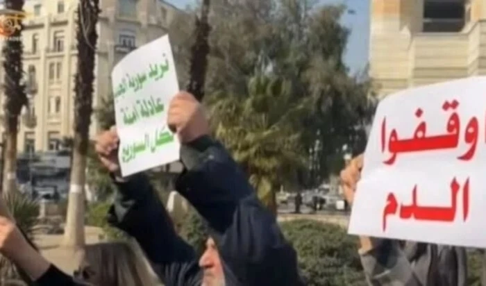 Manifestante en Damasco sostiene un cartel con las palabras: "Detengan la sangre". 9 de marzo de 2025 Manifestante en Damasco sostiene un cartel con las palabras: "Detengan la sangre". 9 de marzo de 2025