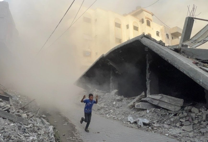 Niño huye de los bombardeos entre los escombros de Gaza (Foto: AFP)