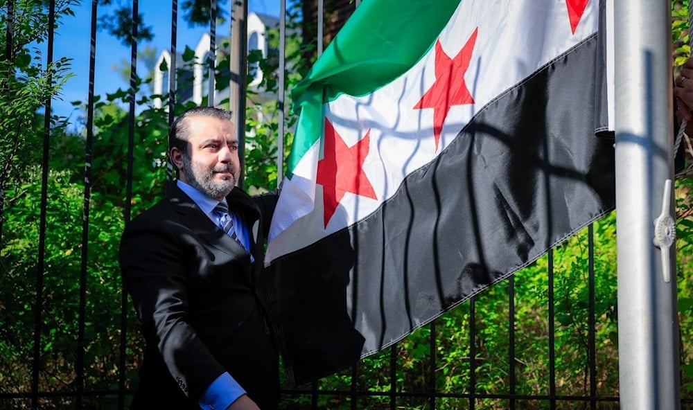 El ministro de Exteriores sirio, Asaad al-Shaibani, izó la bandera en la sede diplomática siria en Washington. (Foto: Agencias)